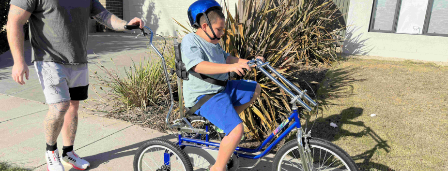 Bike recipient Harry riding his custom bike